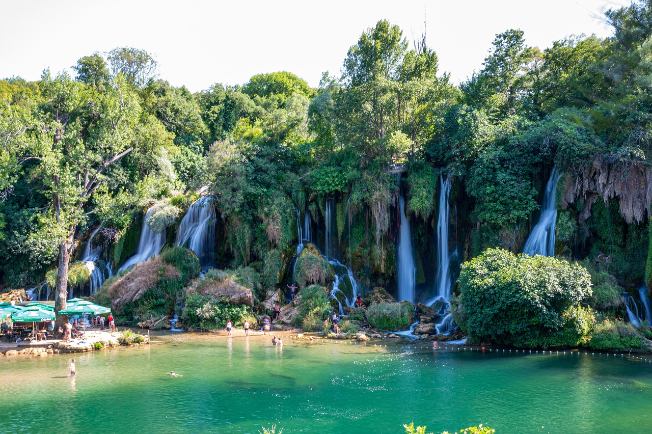 Kravica Waterfalls panoramic view with turquoise water and lush vegetation