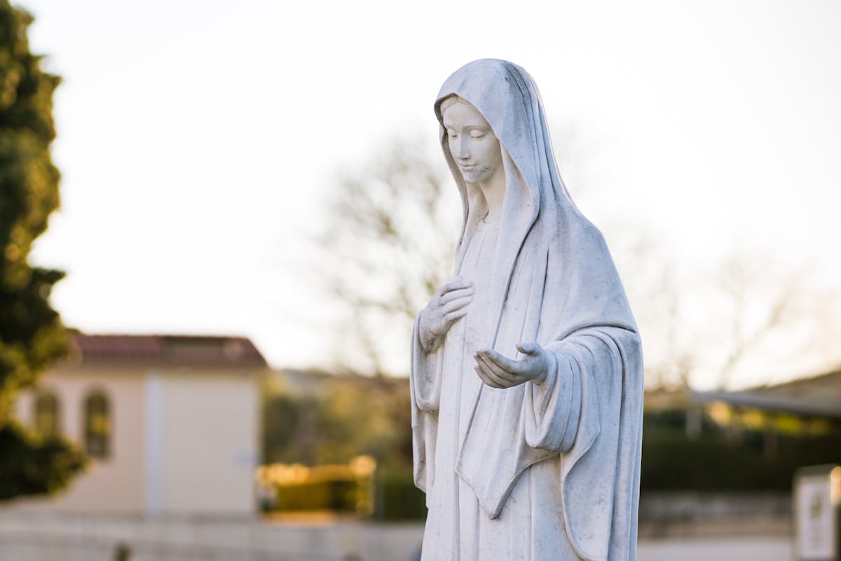 Statue of Virgin Mary in Medjugorje at sunset
